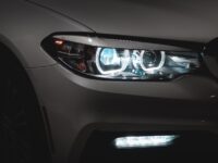 gray car with white and blue lights